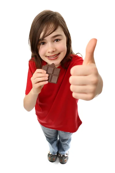 Girl eating chocolate showing thumb up — Stock Photo, Image