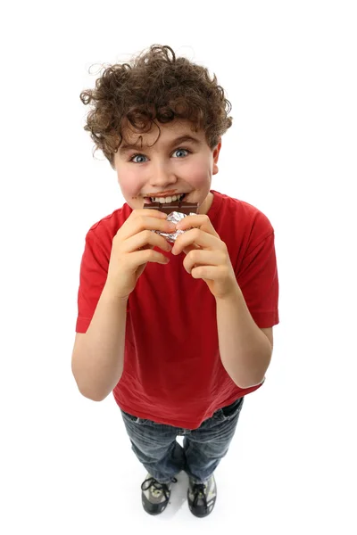 Menino comendo chocolate — Fotografia de Stock