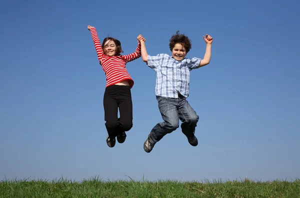 Girl and boy jumping outdoor Royalty Free Stock Photos