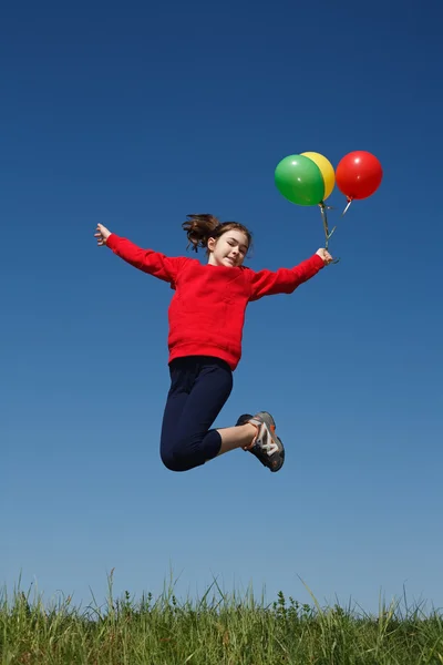 Girl jumping with balloons — Stock Photo, Image