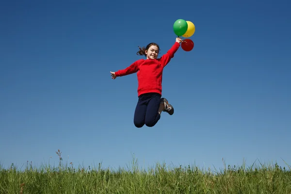 Девушка прыгает с воздушными шарами — стоковое фото