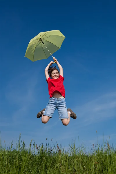 Girl jumping, flying with green umbrella — Stock Photo, Image