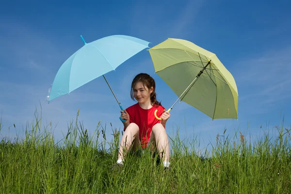 Girl jumping with umbrella against blue sky — Stock Photo, Image