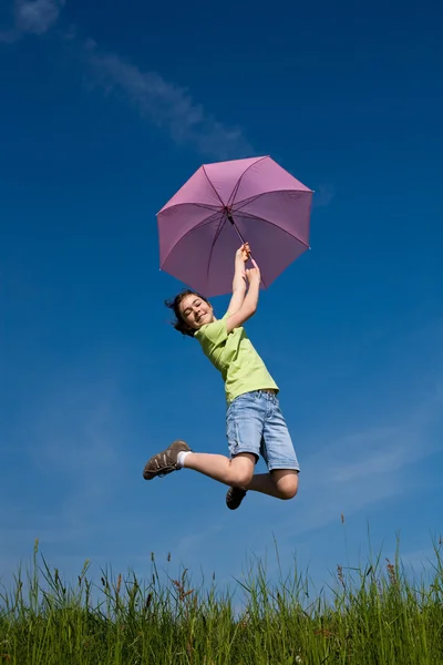 Girl jumping, flying with purple umbrella — Stock Photo, Image