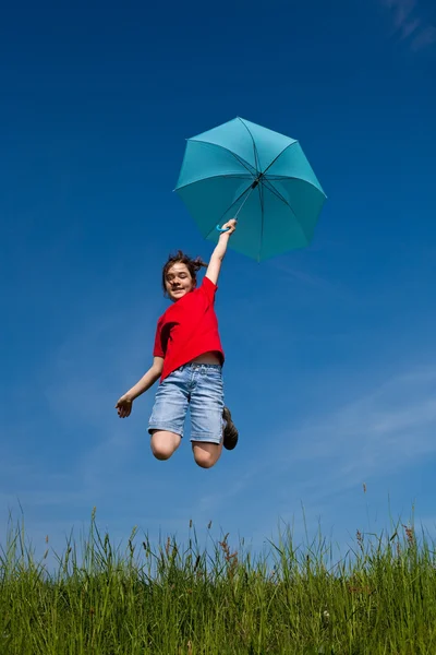 Girl jumping, flying with blue umbrella — Stock Photo, Image