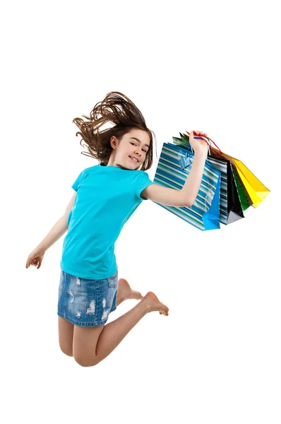 Jovem pulando com sacos de compras — Fotografia de Stock