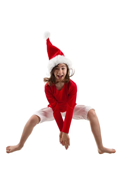 Menina no chapéu de Papai Noel saltando — Fotografia de Stock