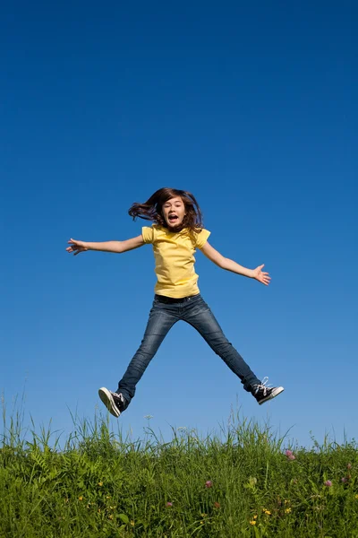 Girl jumping against blue sky — Stock Photo, Image