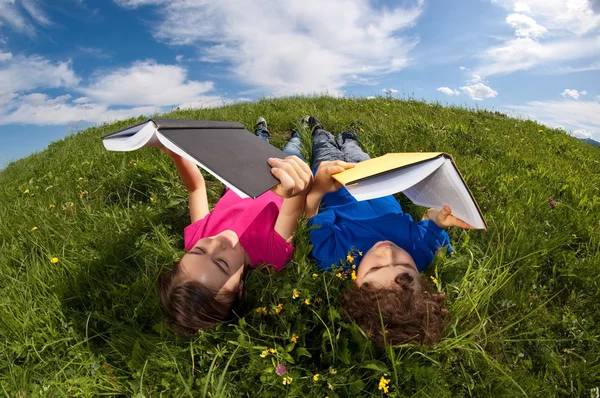 Niños relajándose en el prado verde —  Fotos de Stock