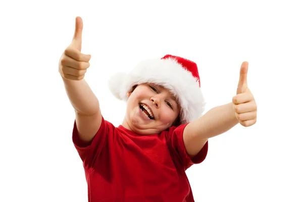 Pojke bär jultomten hatt med tummen upp — Stockfoto
