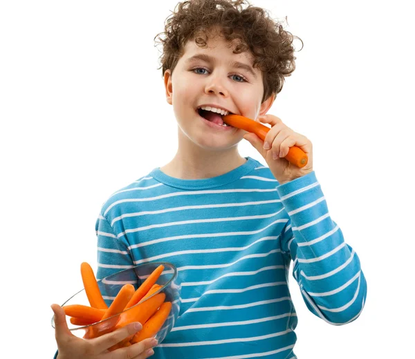 Boy eating fresh carrots — Stock Photo, Image
