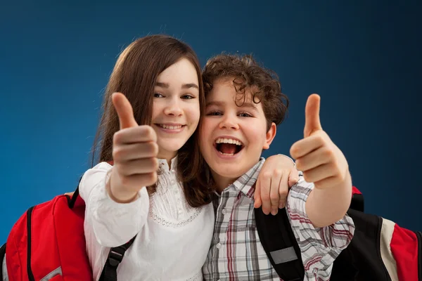 Boy and girl showing thumbs up sign — Stock Photo, Image