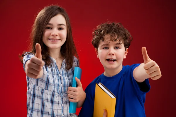 Boy and girl showing thumbs up sign — Stock Photo, Image