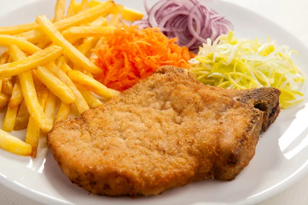 Fried chop pork, french fries and vegetable salad — Stock Photo, Image