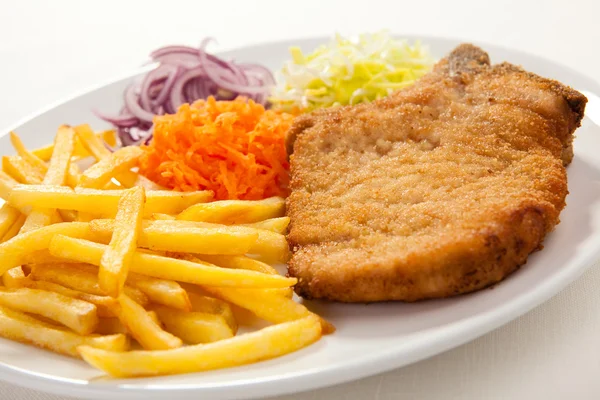 Fried chop pork, french fries and vegetable salad — Stock Photo, Image