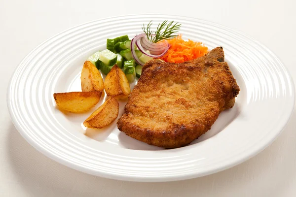 Fried chop pork, chips and vegetable salad — Stock Photo, Image