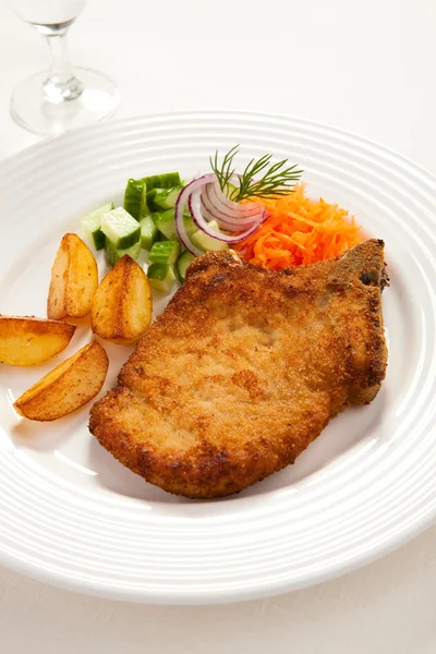 Fried chop pork, chips and vegetable salad — Stock Photo, Image