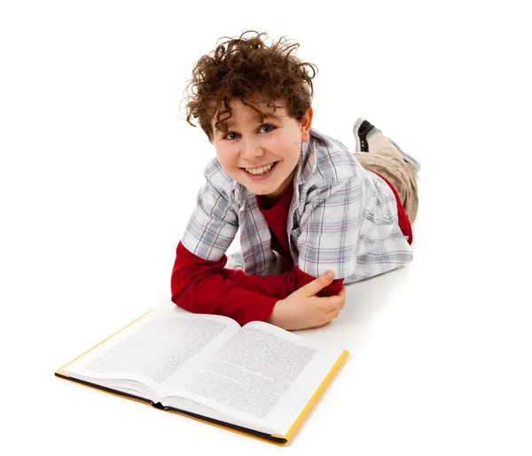 Menino mentiroso e livro de leitura — Fotografia de Stock