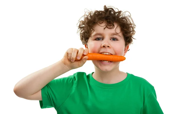 Boy eating fresh carrot — Stock Photo, Image