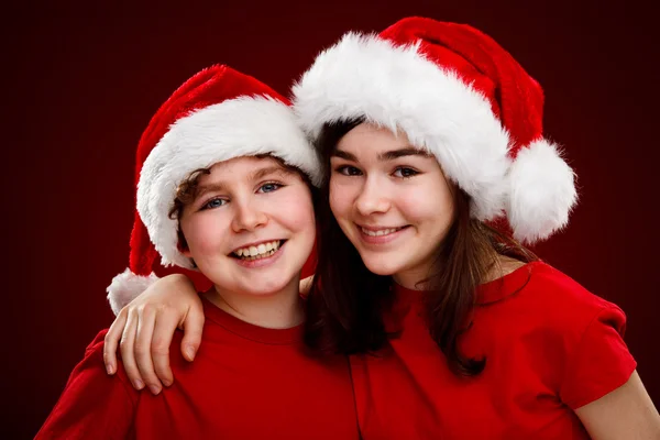 Boy and girl with Santa Claus Hats — Stock Photo, Image