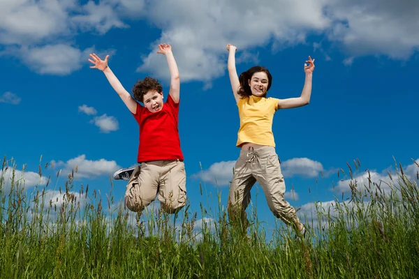 Girl and boy jumping, running — Stock Photo, Image