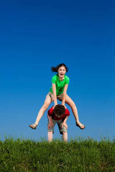 Girl and boy jumping, running — Stock Photo, Image