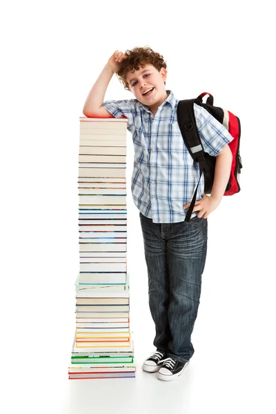 Estudante perto da pilha de livros — Fotografia de Stock