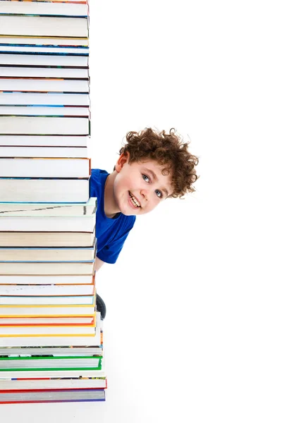 Student nära högen av böcker — Stockfoto