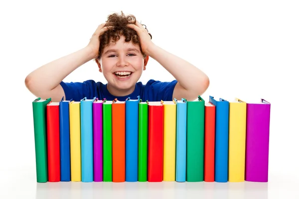 Estudante com pilha de livros — Fotografia de Stock