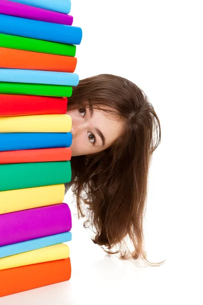 Estudante sentado perto de pilha de livros — Fotografia de Stock