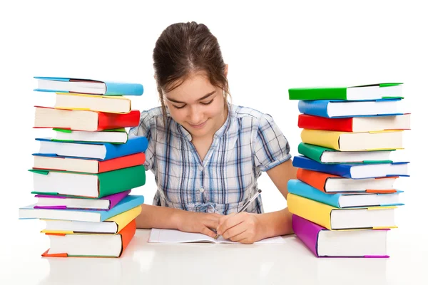 Estudante perto da pilha de livros — Fotografia de Stock