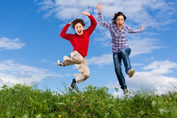 Girl and boy jumping — Stock Photo, Image