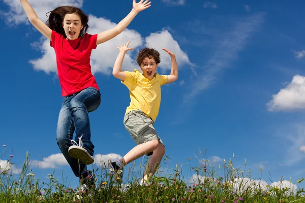 Girl and boy jumping Stock Picture