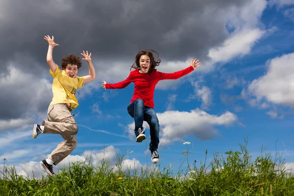 Chica y niño saltando — Foto de Stock