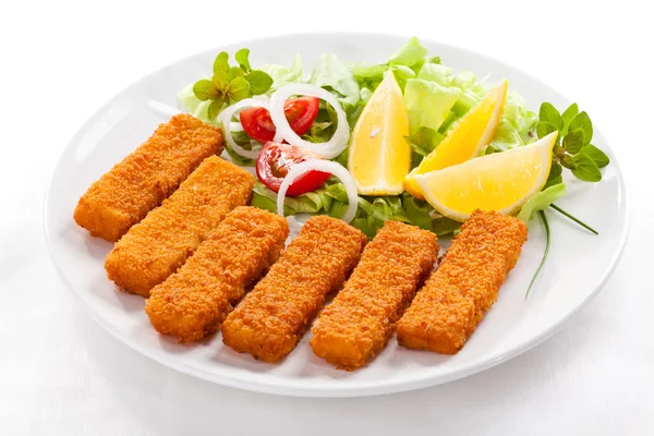 Fried fish fingers and vegetables Stock Image