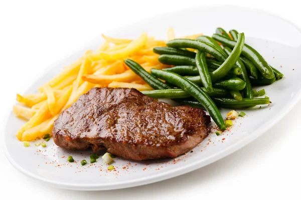 Grilled steak, French fries and green beans — Stock Photo, Image