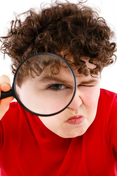 Boy looking through magnifying glass — Stock Photo, Image