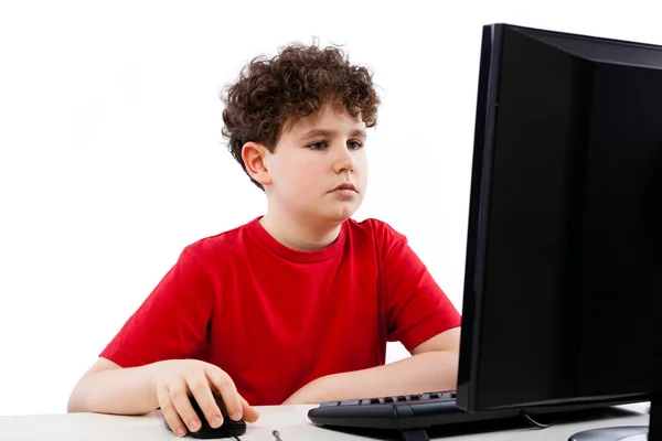 Junge benutzt Computer Stockbild
