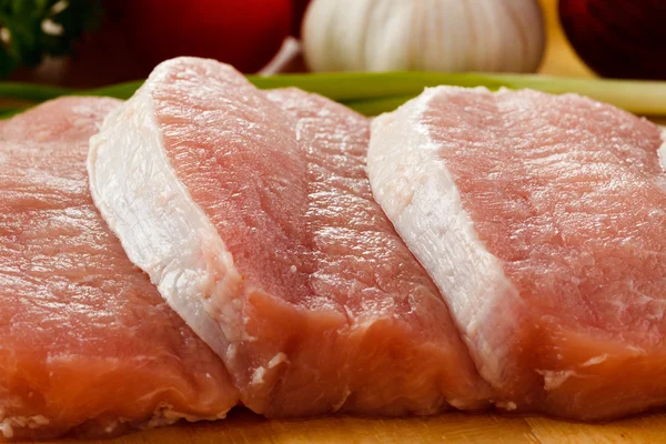 Raw pork on cutting board — Stock Photo, Image