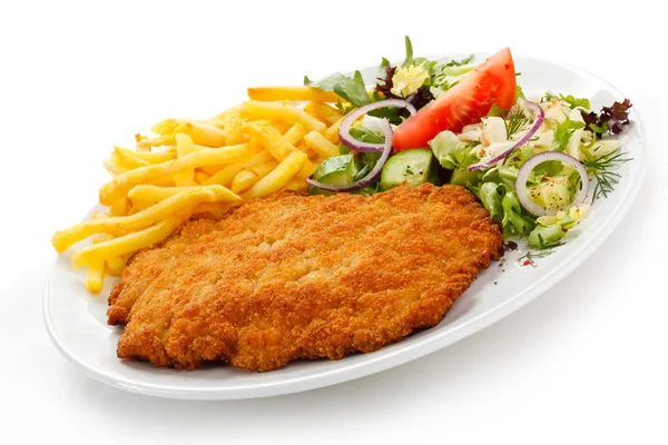 Fried pork chop, French fries and vegetables — Stock Photo, Image