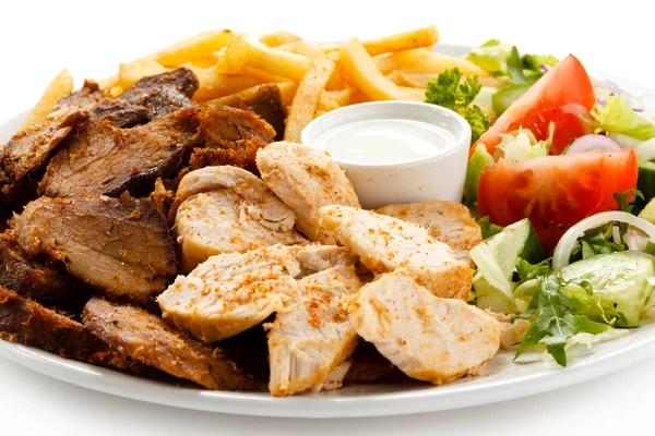 Grilled meat with fried potatoes and vegetable salad — Stock Photo, Image