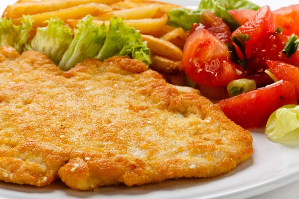 Pork chop, French fries and vegetables — Stock Photo, Image