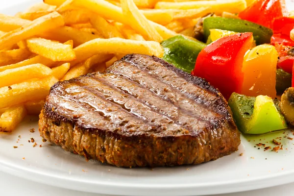 Grilled steak, French fries and vegetables — Stock Photo, Image