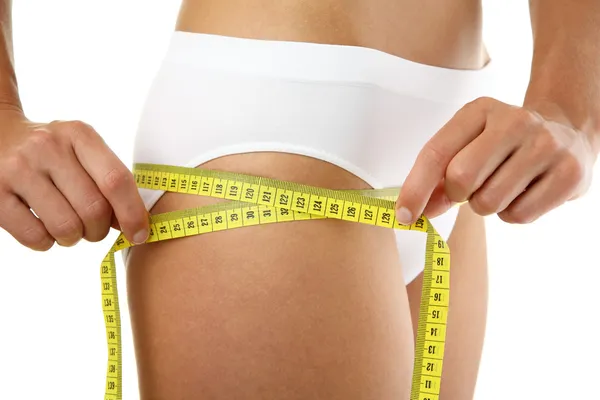 Woman measuring her slim body — Stock Photo, Image