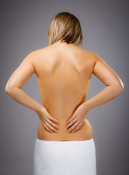 Woman massaging pain back — Stock Photo, Image