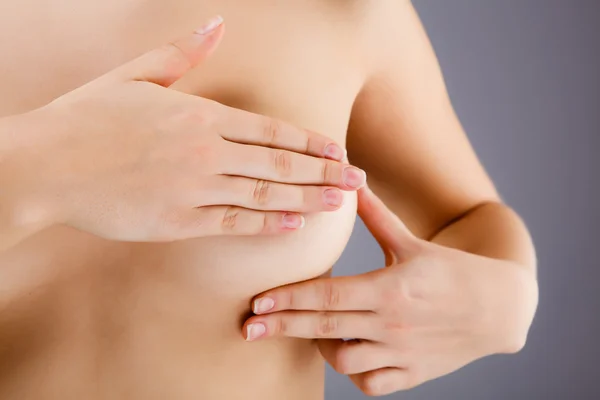 Woman examining breast — Stock Photo, Image