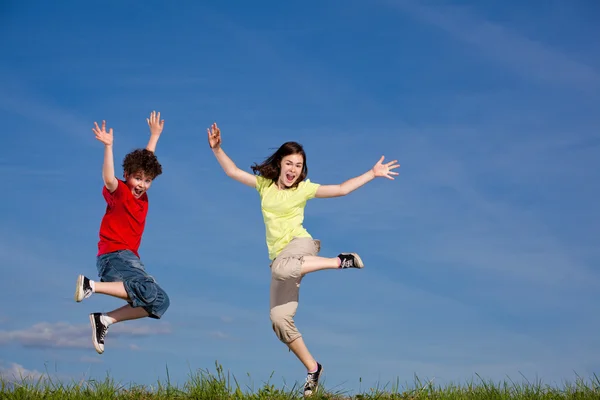Girl and boy jumping, running outdoor Stock Photo
