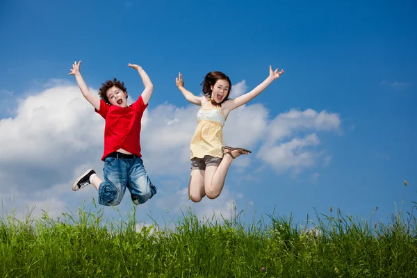 Girl and boy jumping, running outdoor — Stock Photo, Image