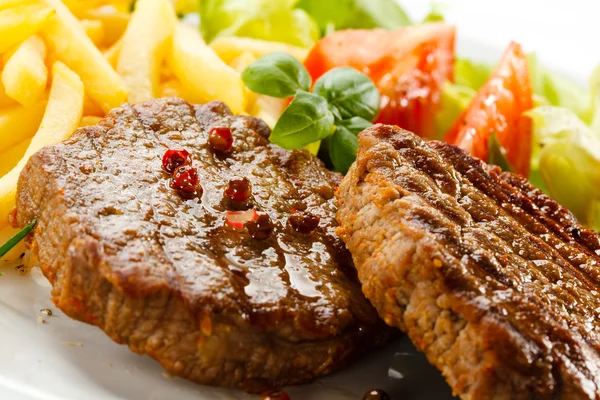 Grilled steak, French fries and vegetables — Stock Photo, Image