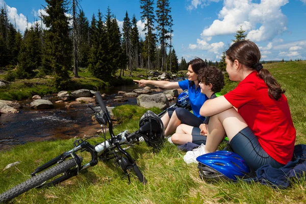 Active family resting after biking — Stock Photo, Image